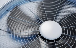 Close-up of air conditioner condenser fan operating in Rowlett TX