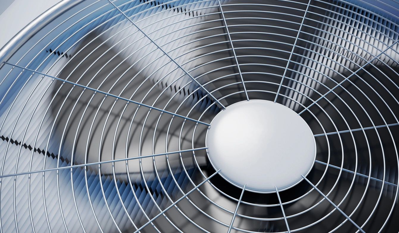 Close-up of air conditioner condenser fan operating in Rowlett TX