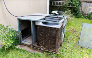 dirty outdoor AC unit with clogged condenser coils in Rowlett TX