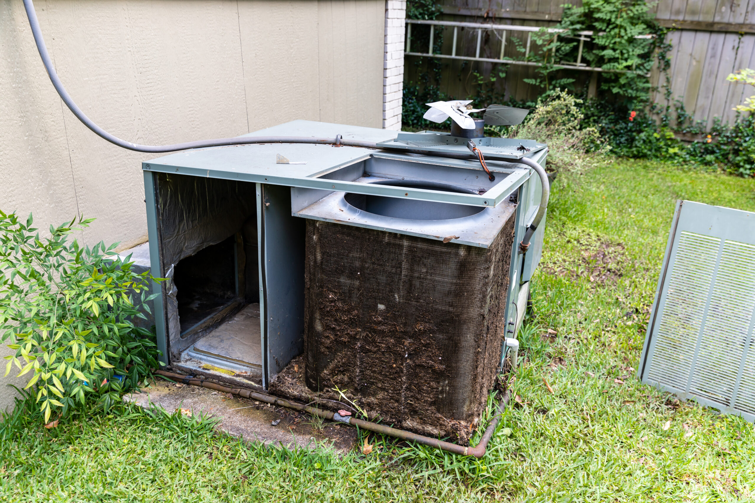 dirty outdoor AC unit with clogged condenser coils in Rowlett TX